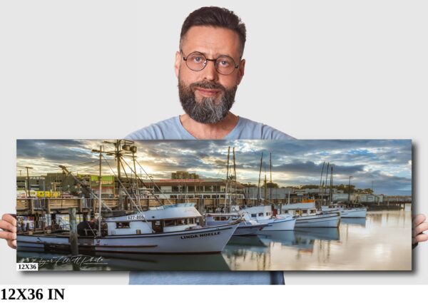 A man is looking at a picture of boats in the water.