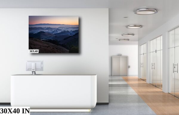 A white room with a large painting of mountains
