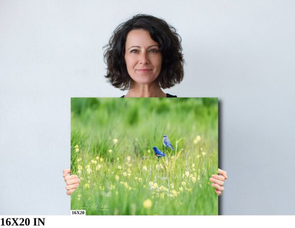 A woman holding up a picture of some flowers