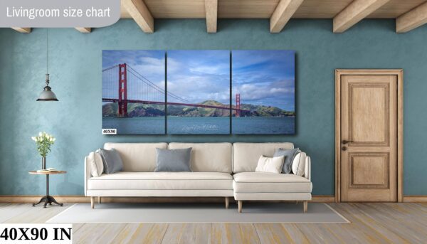 A living room with a couch and a painting of the golden gate bridge.