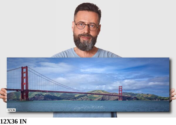 A man standing in front of a painting of the golden gate bridge.