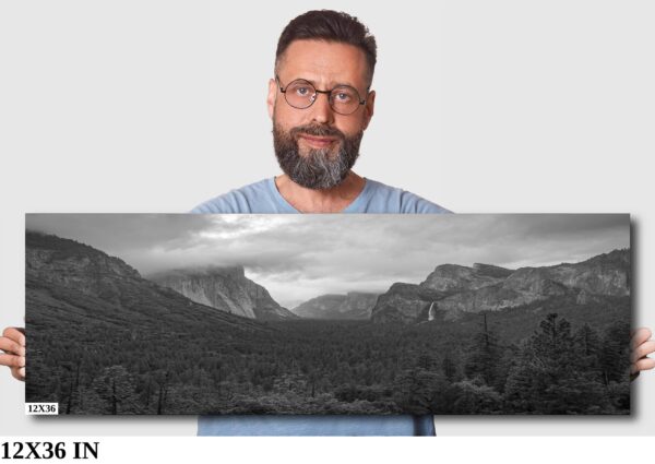 A man standing in front of a picture.