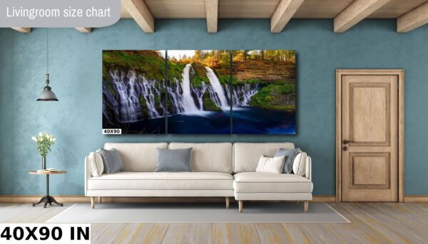 A living room with a couch and a large painting of a waterfall