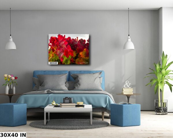 A bedroom with blue furniture and a large painting of flowers.