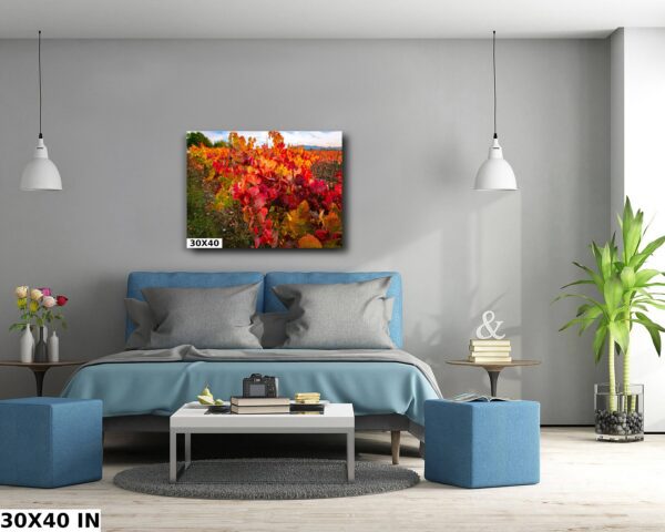 A bedroom with blue furniture and a painting on the wall.