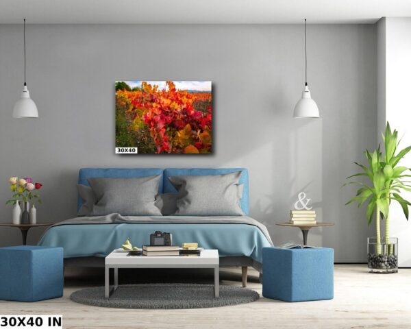 A bedroom with blue furniture and a painting on the wall.