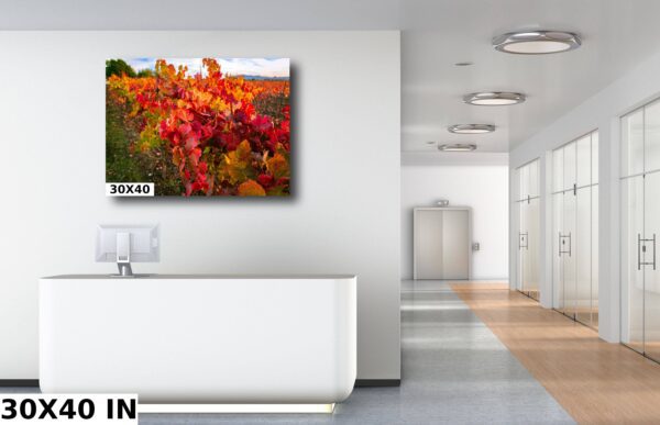 A large painting of flowers in the middle of a room.