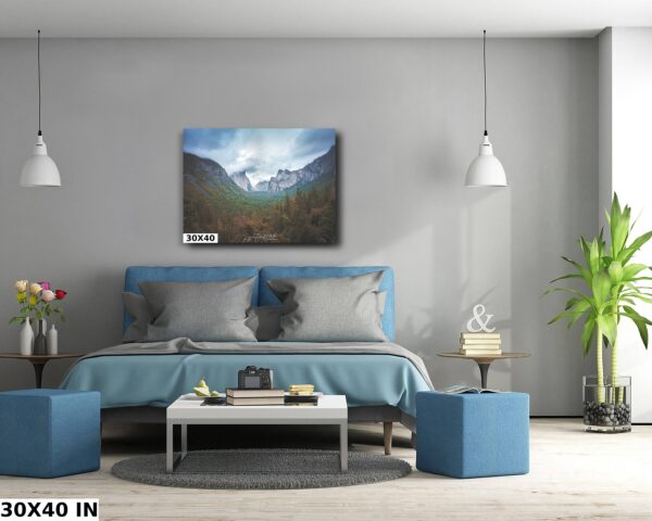 A bedroom with a bed and two blue ottomans