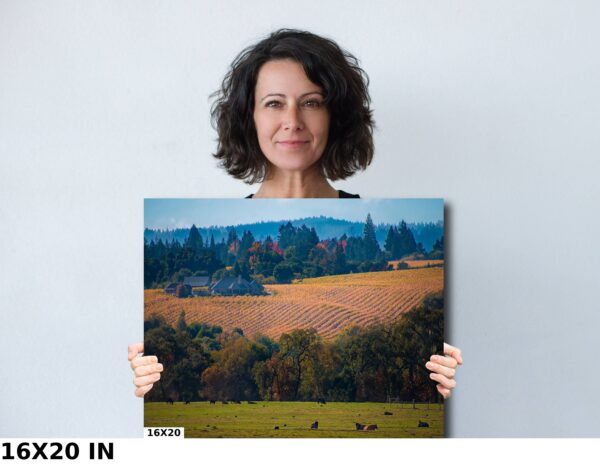 A woman holding up a picture of a field.