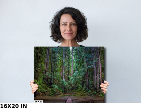 A woman holding up a picture of trees