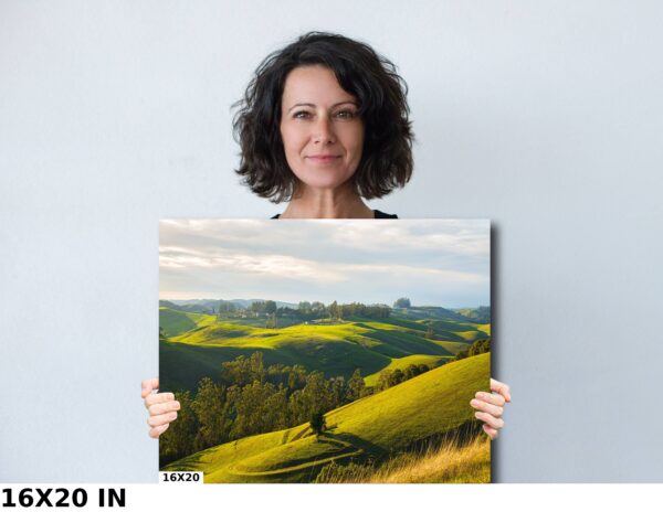 A woman holding up a picture of a field.