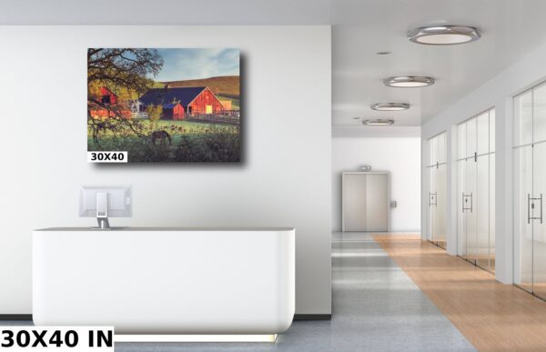 A large painting of a barn and some trees