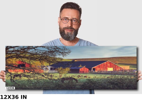 A man holding up a large picture of some barns