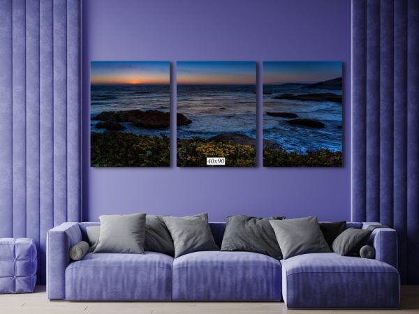 A living room with purple walls and blue couch