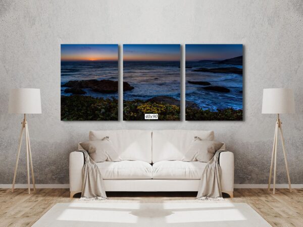A living room with a couch and three pictures on the wall
