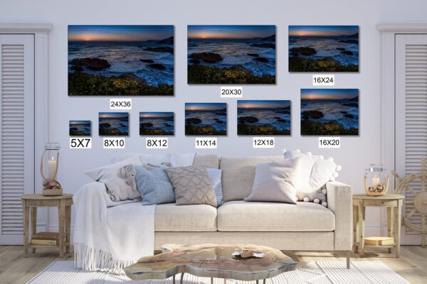 A living room with a couch and several pictures of the ocean