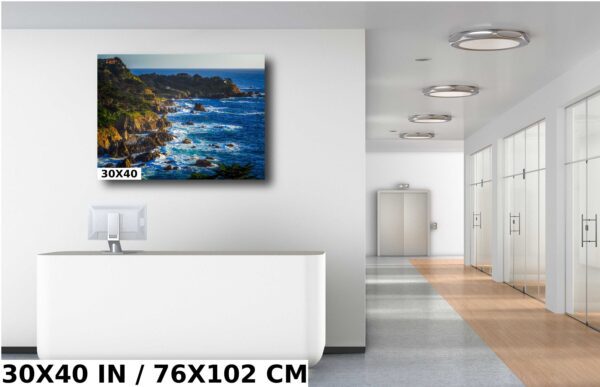 A painting of the ocean and trees in a room.