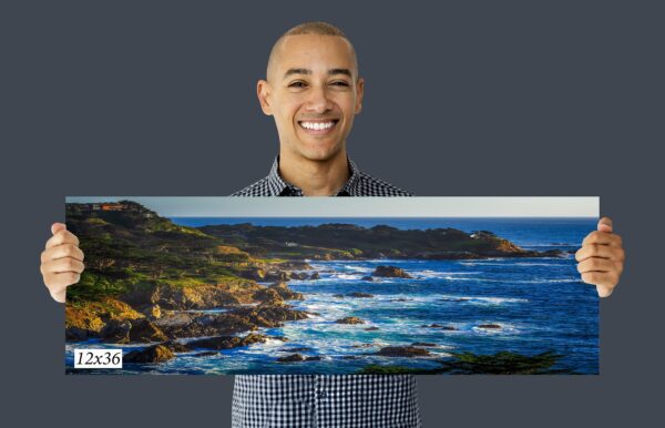 A man holding up an image of the ocean.
