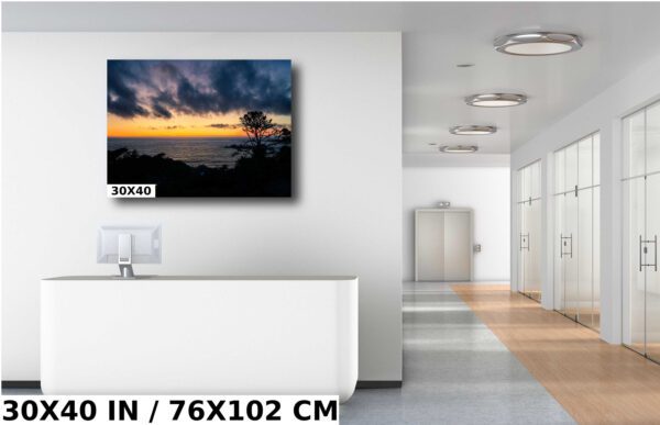 A room with a white wall and a large painting of the ocean
