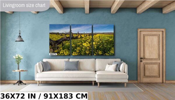 A couch and some chairs in front of a wall with pictures