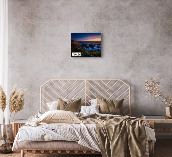 A bed room with a painting of the ocean