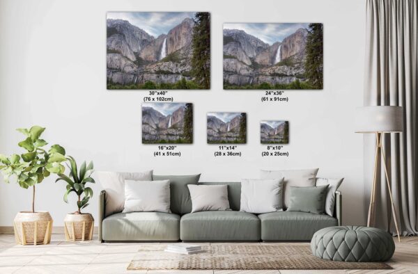A living room with couches and pillows and a wall hanging