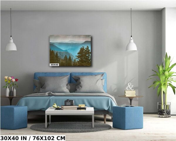 A bedroom with a blue bed and a painting of mountains