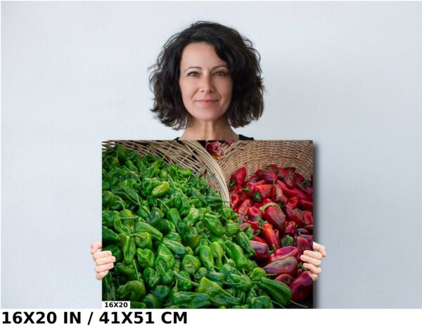A woman holding up a picture of peppers and apples.