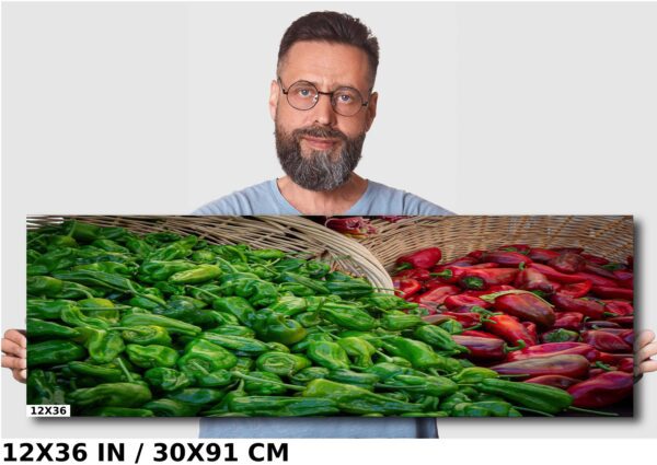 A man standing next to a basket of peppers.