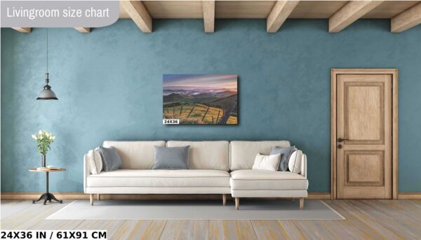A living room with a couch and a painting on the wall