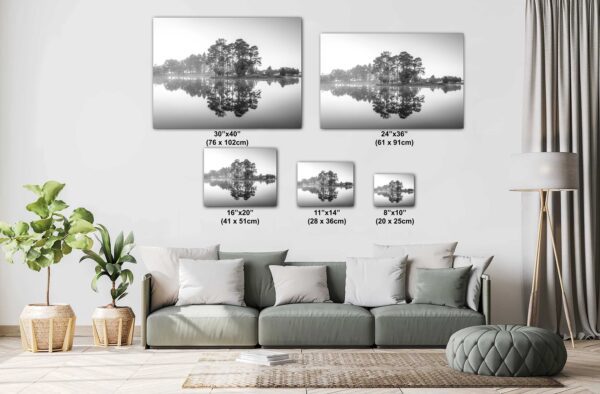 A living room with couch and pillows and two pictures