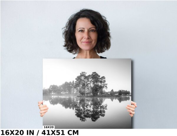 A woman holding up a picture of trees