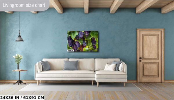 A couch and pillows in front of a wall with a picture.