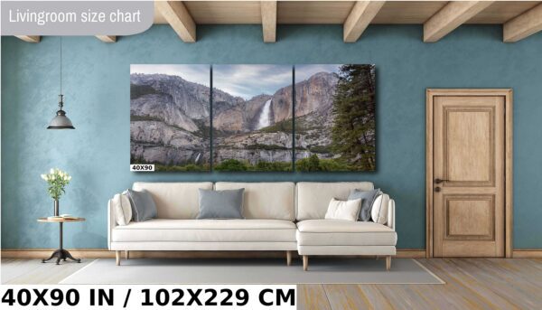 A large picture of a waterfall in the mountains.