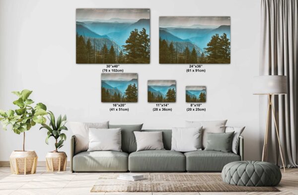 A couch with pillows and a painting of mountains