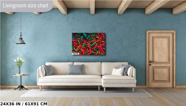 A painting of red peppers on the wall above a couch.
