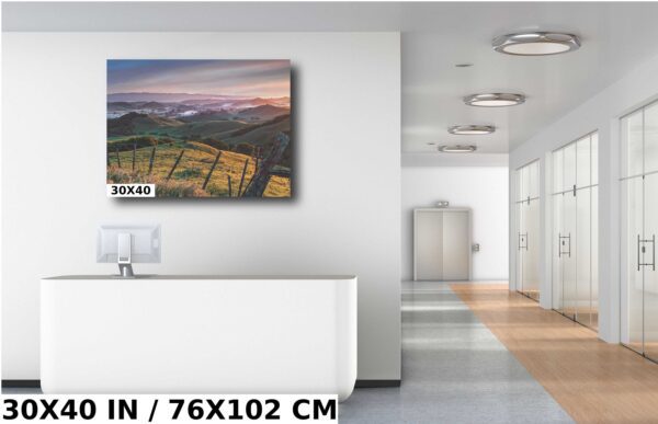 A large painting of a sunset over the mountains