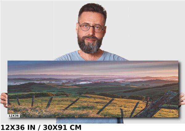 A man standing in front of a large painting.