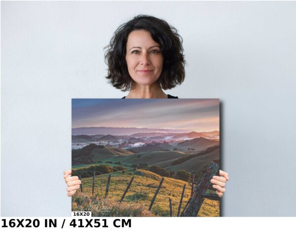 A woman holding up a picture of a field