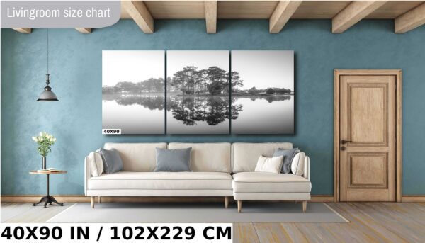 A large painting of trees and water in black and white
