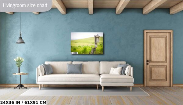A couch and pillows in front of a wall with a painting.