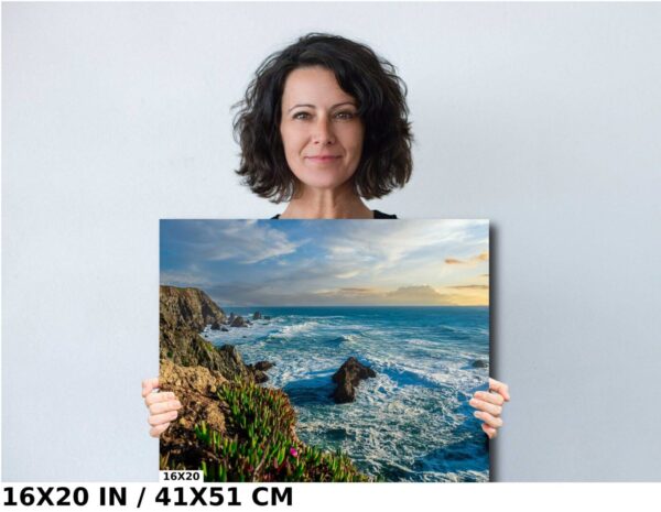 A woman holding up a picture of the ocean.