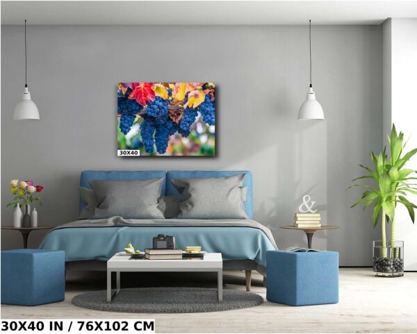 A bedroom with blue furniture and a painting of football players.
