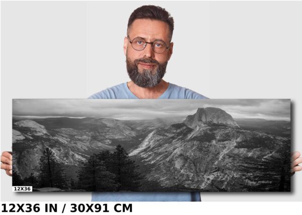 A man standing next to a mountain range.