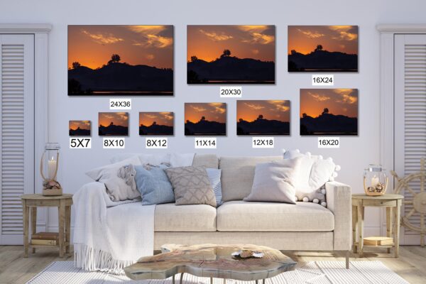 A living room with a couch and several different sizes of pictures