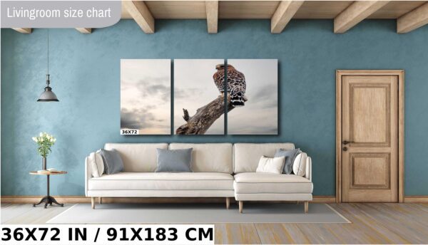 A giraffe is sitting on top of a tree.