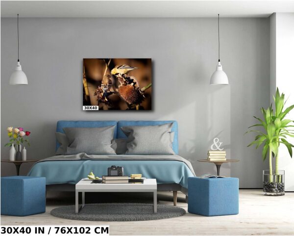 A bedroom with blue furniture and a painting on the wall.