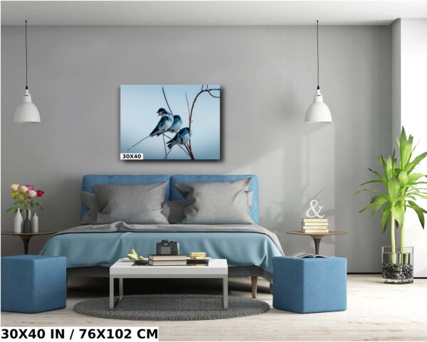 A bedroom with a blue bed and a painting on the wall
