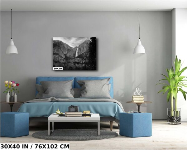 A bedroom with a blue bed and gray walls