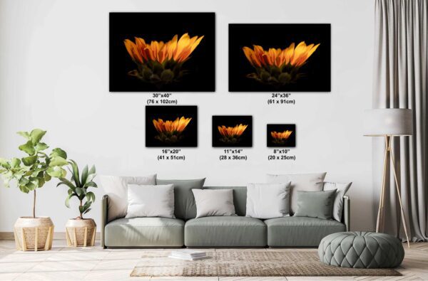 A couch with pillows and a picture of flowers.
